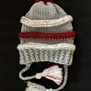 Image of a slouchy red, grey and light pastel knit hat