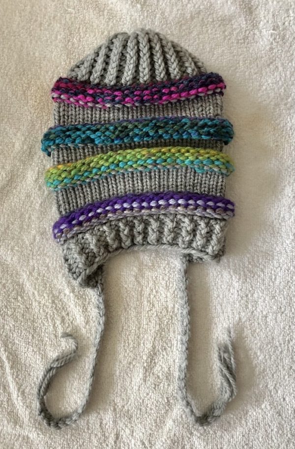 Image of a slouchy multi coloured and grey knit hat
