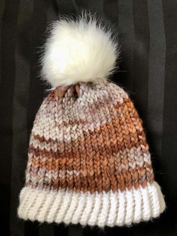 Image of a brown and white knit hat