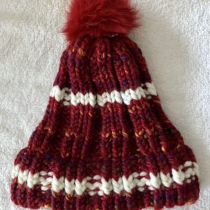 Image of a multi hued red and white knit hat