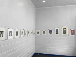 This is a photo of the AANM Gallery displaying Kelly Haydon's prints.  The walls are white.