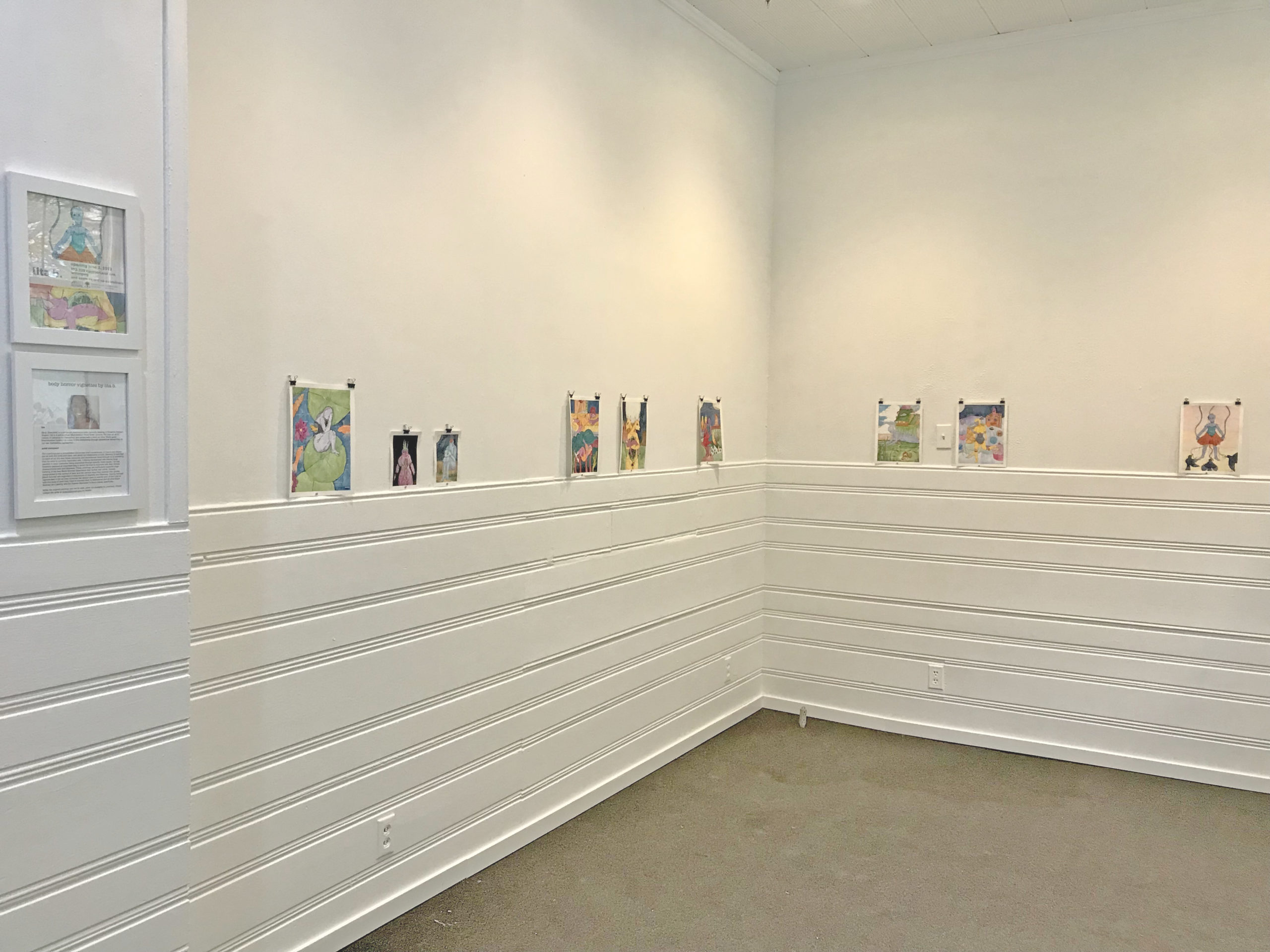 This is a photo of the AANM Gallery displaying artwork by lita b. The walls are white.