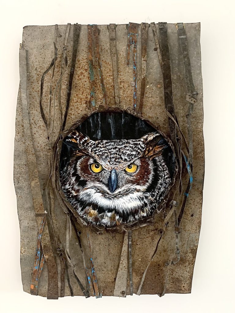 This is a photo of an artwork. A Brown owl in a tree painted with acrylic on recycled tin