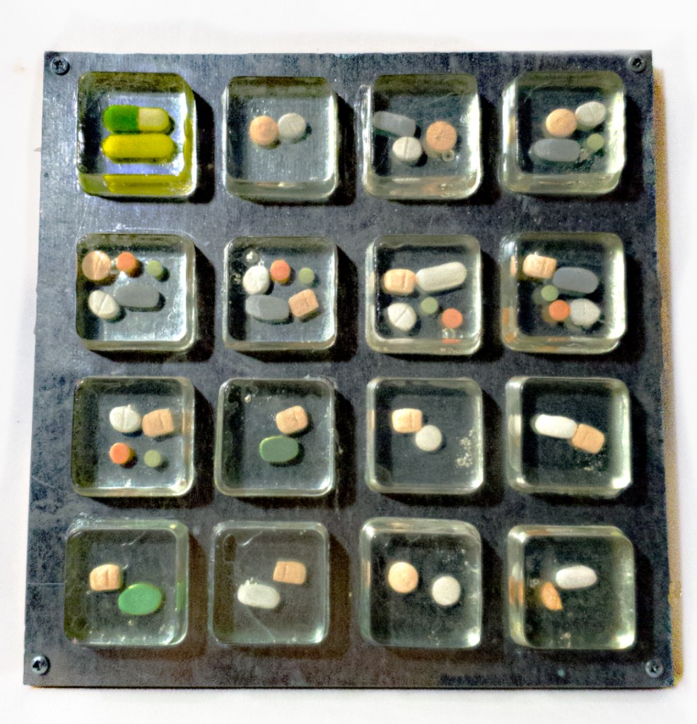 this is a photograph of a variety of medication and medication combinations enclosed in resin.
