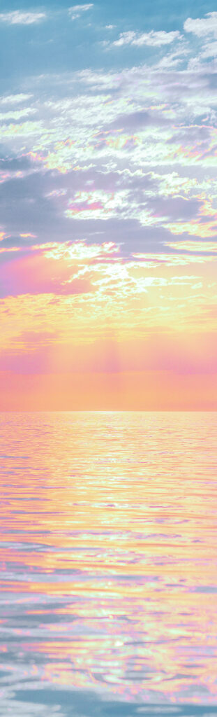 This photograph of a sunset over water has been manipulated to highlight cotton-candy colours. The teal sky is strewn with lilac clouds. Silver light lines the clouds, which shift to magenta and orange at the horizon. Below, the calm sea ripples with pink, lilac, and orange light.