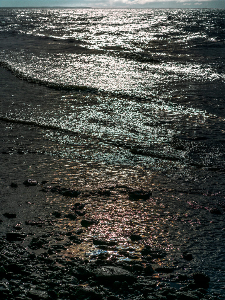 This simple photo of waves lapping onto a pebble-strewn beach has been manipulated to appear dark and oily. While beautiful and iridescent, the tone is slightly foreboding; is this an oil spill sparkling on the water’s surface?