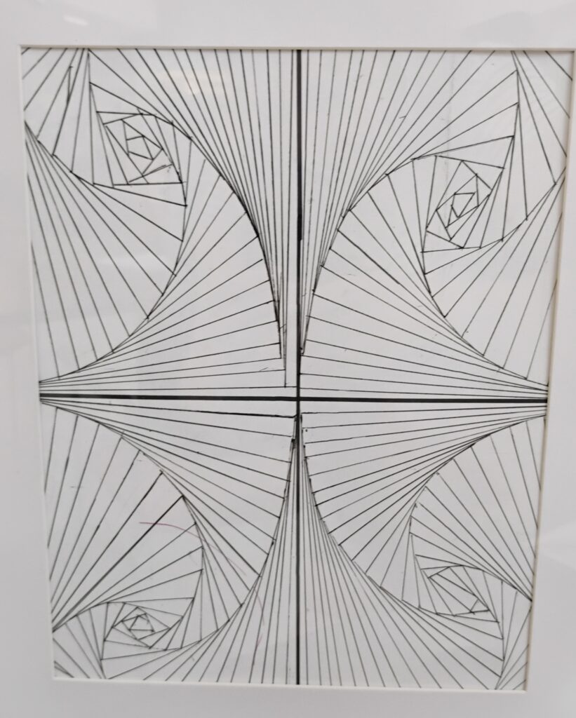 Photograph of artwork featuring geometric shapes in pencil on white paper