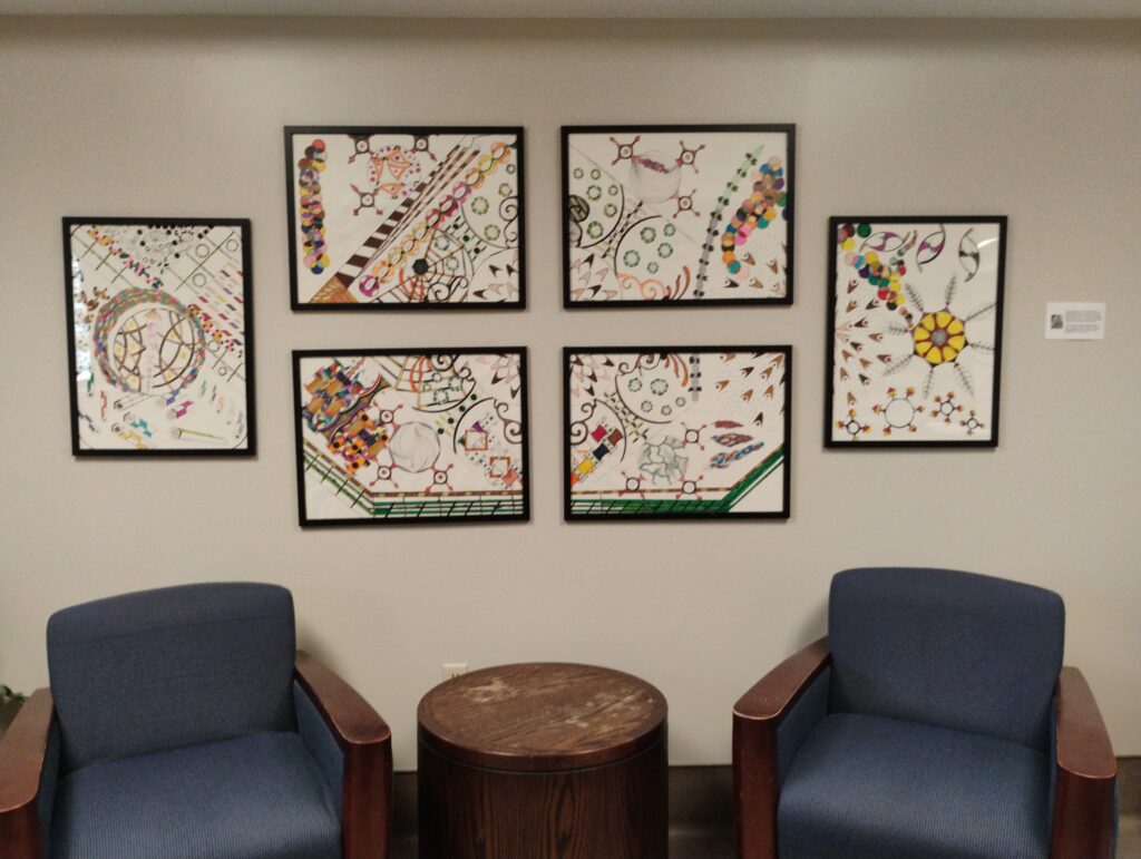 Photograph of six panels of artwork featuring geometric shapes and many colours